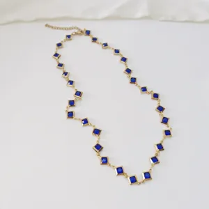 Elegant gold-plated stainless steel necklace featuring vibrant blue square crystals detail