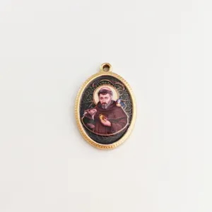Detailed macro view of a vintage religious figure pendant with polished golden frame
