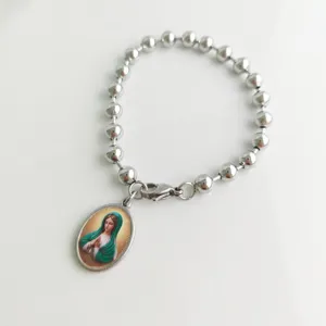 Detailed view of a stainless steel bead bracelet with a Virgin Mary oval pendant