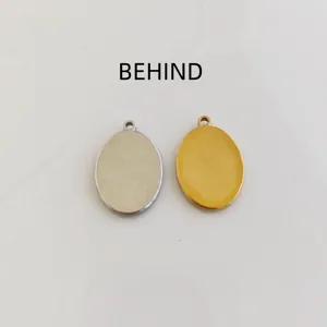 Reverse side view of silver and gold stainless steel oval pendants for DIY rosary jewelry