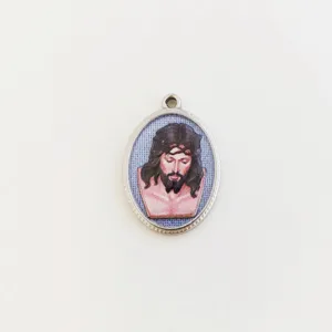 Detail of oval stainless steel pendant with 3D printed Jesus Christ portrait.