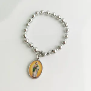 Detail of stainless steel bead bracelet featuring a religious Saint medal pendant