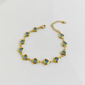 High-quality detailed view of gold stainless steel bracelet with elegant blue heart charms