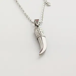 Detailed macro view of a vintage punk stainless steel wolf fang pendant necklace