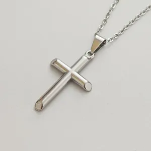 High-quality detailed view of a minimalist silver stainless steel cross pendant