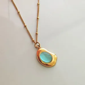 Close-up of a vintage 18K gold plated stainless steel necklace with blue stone