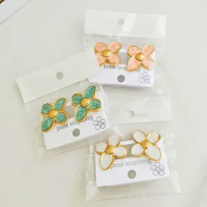 Detailed view of colorful stainless steel flower earrings with enamel finish in packaging