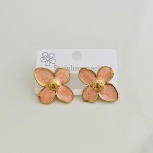 Detailed view of pink enamel four-petal flower stud earrings with gold stainless steel edges.
