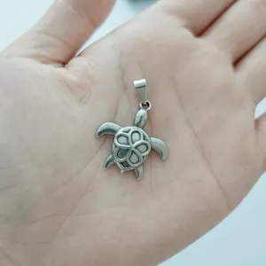 Stainless steel sea turtle pendant with flower pattern detail, ocean themed accessory