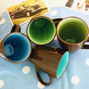 Matte brown ceramic mug with colorful glazed interior and sturdy handle