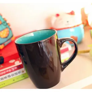 Minimalist Japanese style dark brown ceramic mug with turquoise interior for office coffee