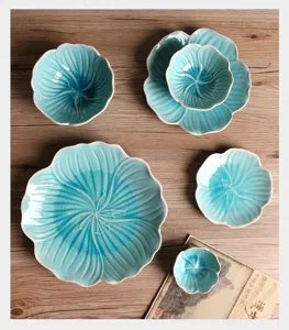 Macro view of blue petal-shaped ceramic plates with crackle glaze detail