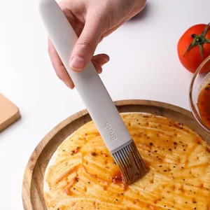 High-quality heat-resistant silicone oil brush for baking and BBQ, shown in kitchen use.
