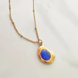 Detailed view of vintage 18K gold plated necklace with a brilliant blue oval stone