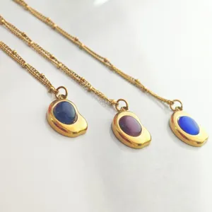 Close-up detail of three retro 18K gold plated necklaces with oval gemstone pendants.