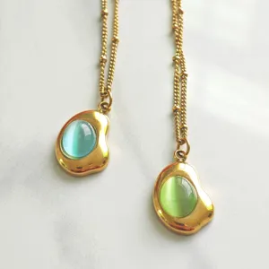 Detailed macro view of vintage stainless steel necklaces with blue and green oval stone pendants