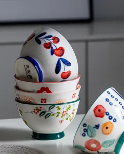 Close-up of exquisite hand-painted floral patterns on stacked ceramic Japanese bowls