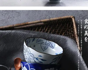 Close-up of Japanese-style underglaze ceramic bowl with wavy rim and blue leaf pattern.