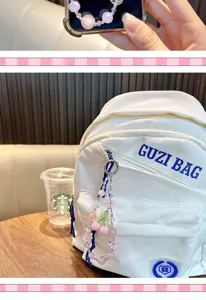 Aesthetic pink cherry beaded charm shown as a decorative accessory hanging on a white backpack