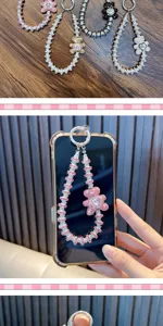 Luxury rhinestone bear phone straps shown in multiple colors with detailed hand-held view.
