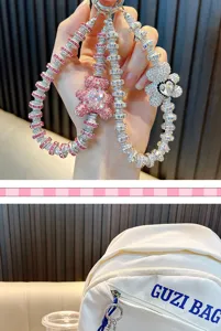 Detailed view of sparkling crystal bear and flower charms used as a bag accessory