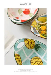 Macro view showing details of colorful ceramic salad bowls with hand-painted fruit patterns
