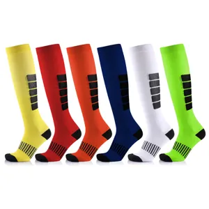 Detail showing six vibrant colors of striped long compression sports socks for running