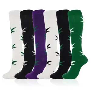 Detailed view of compression socks in multiple colors with white, black, purple, and green.