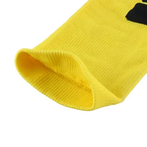 Macro view of high elasticity ribbed cuff on a professional yellow compression sock