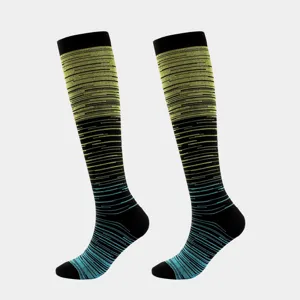 Close-up detail of gradient striped compression socks in black with neon yellow and blue
