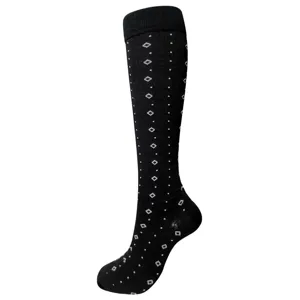 Vue détaillée de chaussettes de compression noires avec motif de losanges blancs.