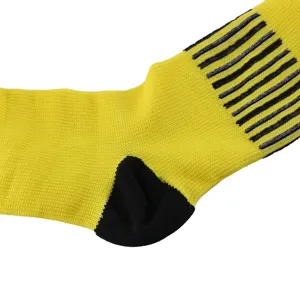 Macro view of yellow athletic compression sock showing black heel detail and stripes.