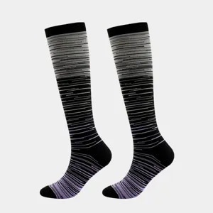Close-up of black compression socks with purple gradient striped pattern and reinforced toe.