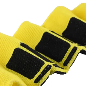 Detailed close-up showing the knit texture and striped pattern of yellow compression socks
