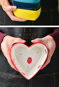 Detailed view of heart-shaped ceramic dessert bowl featuring cute strawberry patterns