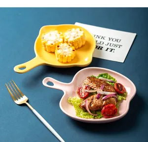 Assiettes en céramique avec poignée servant des ailes de poulet et du maïs