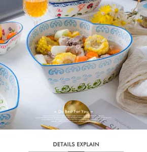 Close-up of heart-shaped ceramic bowl with blue floral patterns containing healthy soup