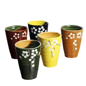 Set of Japanese-style hand-painted ceramic cherry blossom tea cups in five unique colors.