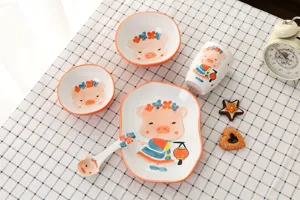 Vue détaillée d'un service de table en céramique pour enfants avec motif de cochon