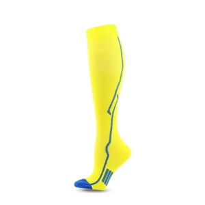 Detailed view of yellow knee-high compression socks with blue athletic pattern