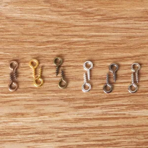 Detailed view of assorted metal screw eye pins in various metallic finishes