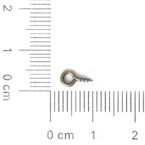 Antique bronze eye screw hook displayed with a centimeter ruler for scale reference