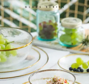 Close-up of premium gold-rimmed glass bowl and plate set in a lifestyle scene
