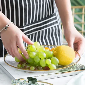 Elegant Japanese-style transparent glass fruit plate with gold rim serving fresh grapes