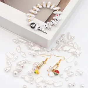 Detailed macro view of irregular white ABS imitation pearls and DIY fruit charm jewelry pieces