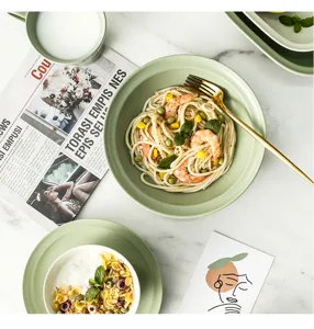 Minimalist mint green ceramic tableware set in a lifestyle dining scene with pasta.
