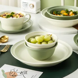 Minimalist Nordic ceramic tableware set featuring matte green and white bowls and plates