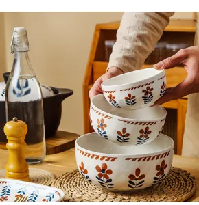 Vue détaillée de trois bols en céramique rétro à motif floral empilés en cuisine