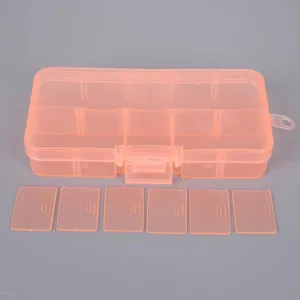Close-up detail of orange transparent plastic jewelry storage box with removable dividers