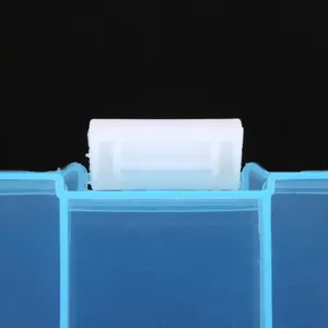 Close-up macro shot of the secure white locking latch on a blue plastic jewelry box